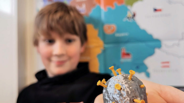 Luca, 6g, vor Deutschlandkarte und Virus-Modell (frisch aus dem 3D-Drucker des CJD Oberurff). Foto: L. Tuzimek/CJD Oberurff